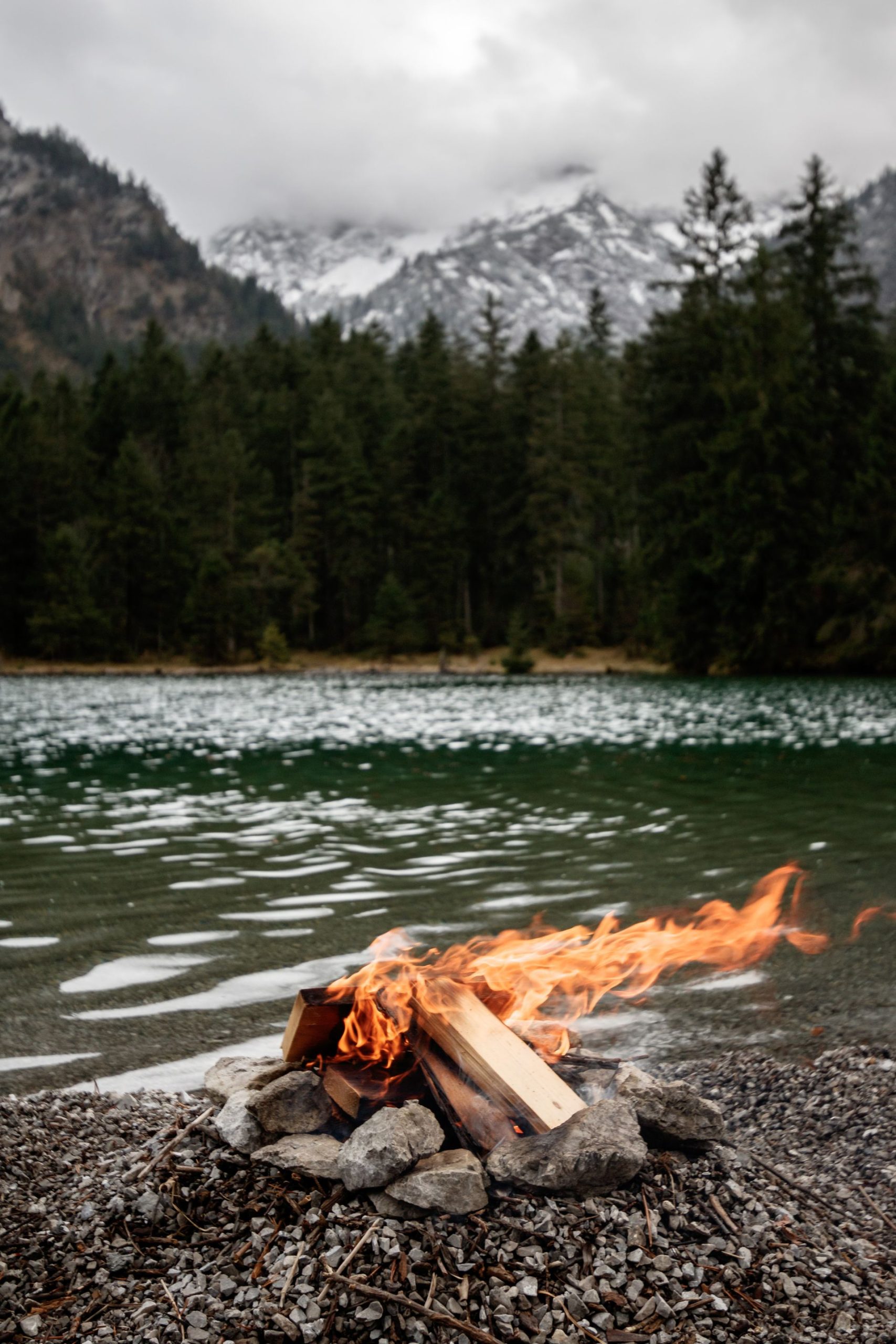 fire-mountain-lake A small fire beside a mountain lake, with a snow-capped view of the mountain in the distance. Reminding us of Anitya, the impermanence of life and death, and the grief of loss.