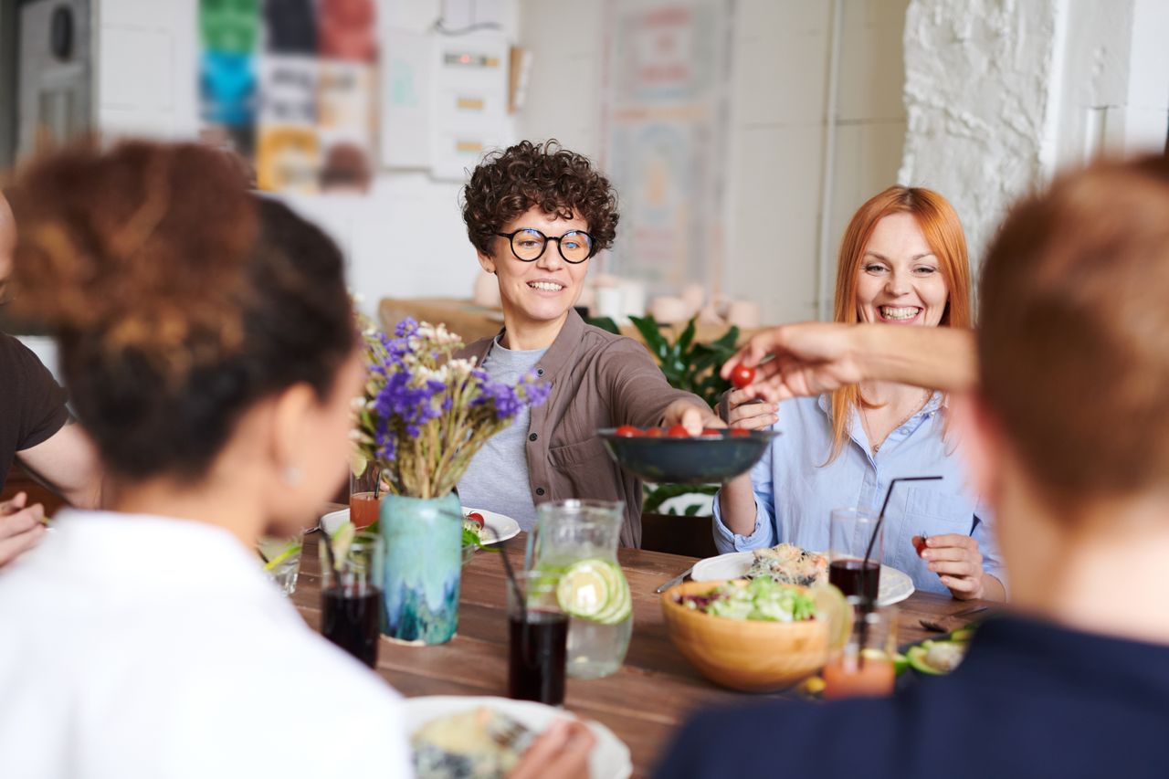 sharing-food A group of friends gathered around a table, sharing food and smiling. Real longevity medicine is about relationships - with your body, community, and the rhythm of the natural world.